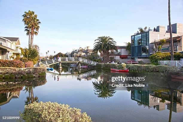 Pedestrian bridge over a canal in the Venice neighborhood in Los Angeles, California. The Venice neighborhood is a local landmark and attraction in...