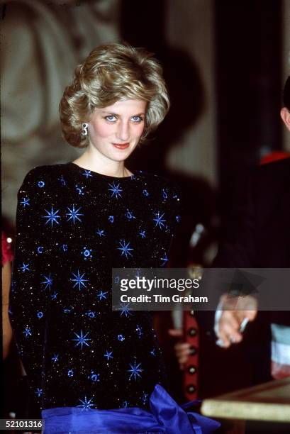 Princess Diana During Her Official Tour Of Florence Wearing A Blue And Black Knee-length Evening Dress Designed By Fashion Designer Jacques Azagury.