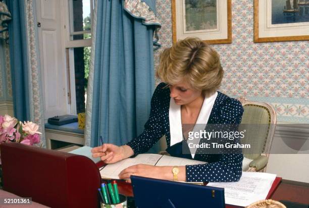 Princess Diana Writing In Her Diary At Her Desk In Her Sitting Room At Home In Kensington Palace, London.