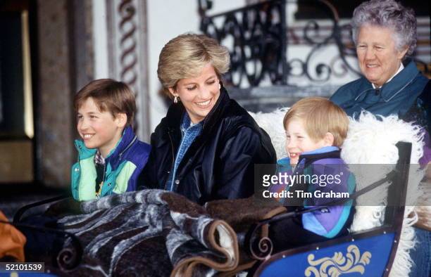 Princess Diana With Prince William And Prince Henry In Lech, Austria. They Are Sitting In A Carriage With A Blanket Covering Them. Sitting Behind Is...