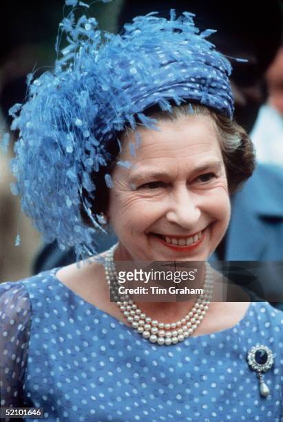 The Queen In The Solomon Isles During Her Official Tour Of The South Pacific Islands Wearing A Hat With Feathers , Three-strand Pearl Necklace And...