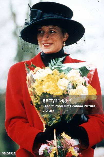 Princess Diana At Sandringham On Christmas Day. The Princess Is Wearing A Red Coat And A Broad-brimmed Black Hat. She Is Carrying A Bouquet Of...