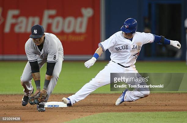 Josh Donaldson of the Toronto Blue Jays slides into second base safely as he leads off the eighth inning with a double during MLB game action as...