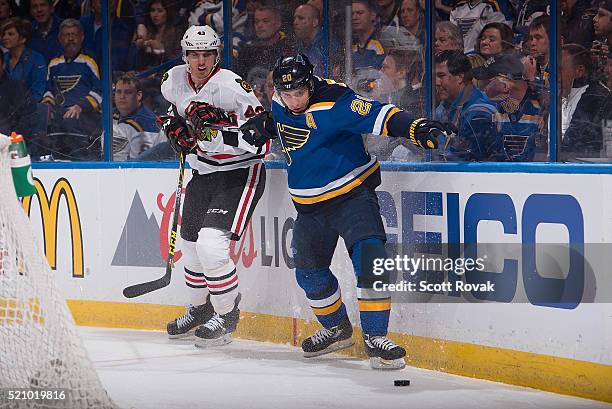 Alexander Steen of the St. Louis Blues and Viktor Svedberg of the Chicago Blackhawks battle for the puck in Game One of the Western Conference...