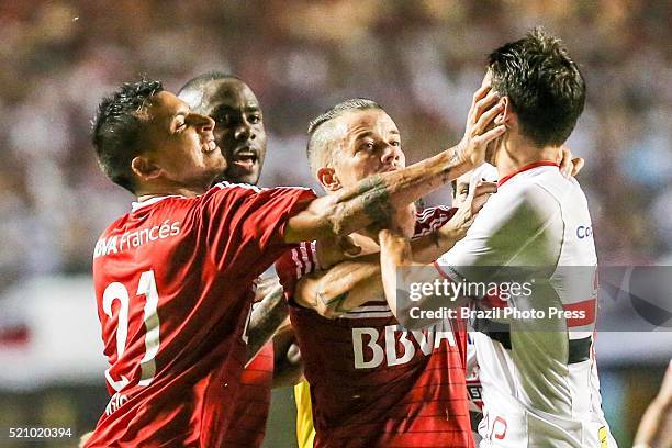 Leonel Vangioni and Andres D'Alessandro of River Plate scuffle with Jonathan Calleri Sao Paulo during a match between Sao Paulo and River Plate as...