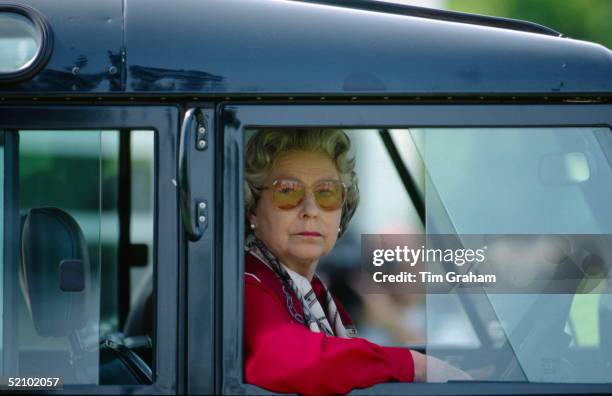 Queen Elizabeth II Sitting At The Wheel Of Her Four Wheel Drive Land Rover Car Watching People Competing At The Royal Windsor Horse Show.