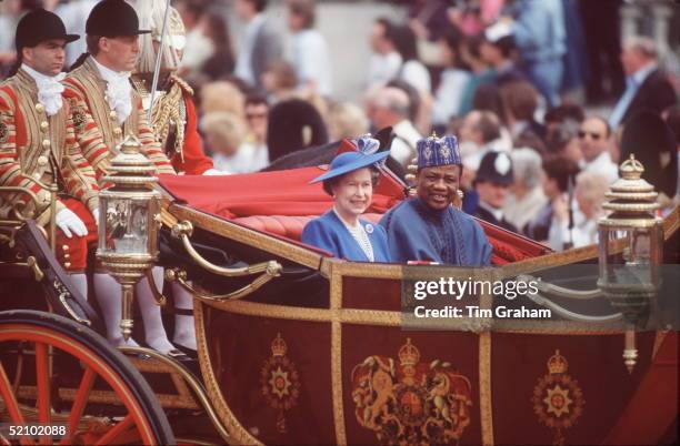 The Queen In A Carriage During The Nigerian State Visit.the Footman On The Back Of The Carriage At Right Behind The President Is In Fact A Royalty...