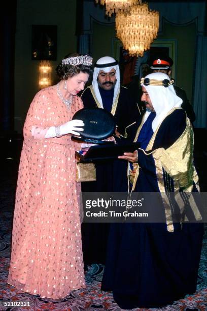 Queen Elizabeth Ll Exchanging Gifts With The Amir Of Bahrain,his Highness Shaikh Isa Bin Sulman Al Khalifa At Qudaibiya Palace,bahrain. The Queen...
