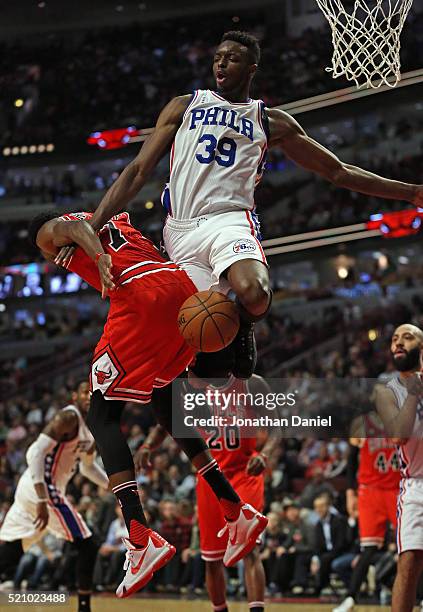 Jerami Grant of the Philadelphia 76ers fouls Justin Holiday of the Chicago Bulls at the United Center on April 13, 2016 in Chicago, Illinois. The...
