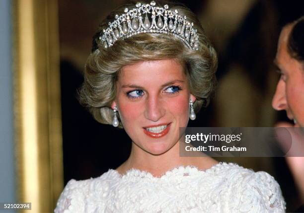 Diana, Princess Of Wales, Talking To Her Husband, During A Visit To The British Embassy. The Princess Is Wearing A Taffeta And Lace Gown With A...