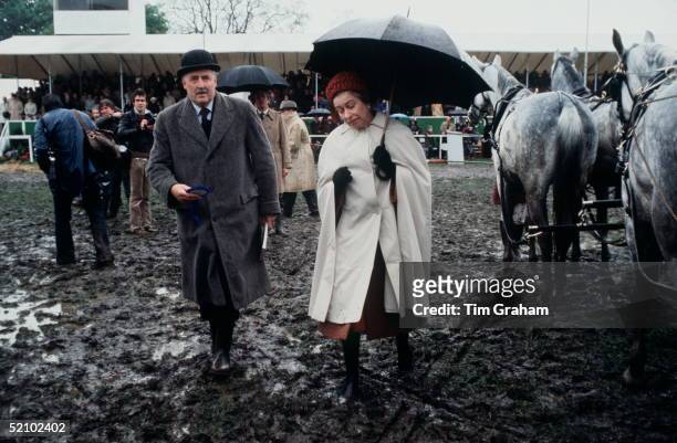 The Queen Walking Through The Mud To Present Prizes At The Windsor Horse Show.