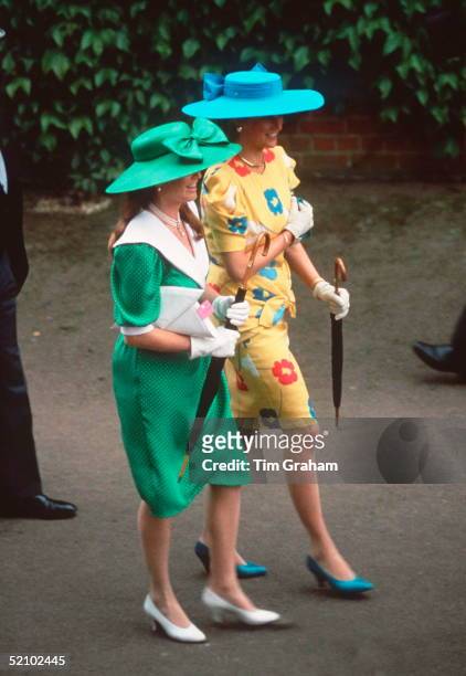 Princess Diana And Sarah, Duchess Of York, Walking Together At Ascot. They Are Both Carrying Umbrellas.