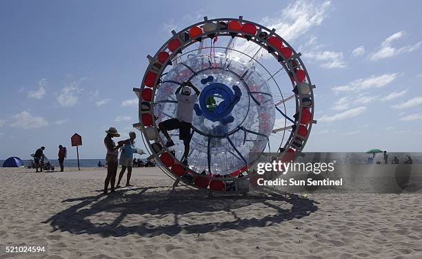 Pat Patrick of Pomano Beach, Fla., friend of adventurer Reza Baluchi, helps tie ropes on the Hydro Pod, which Baluchi plans to take on an 3,500-mile...