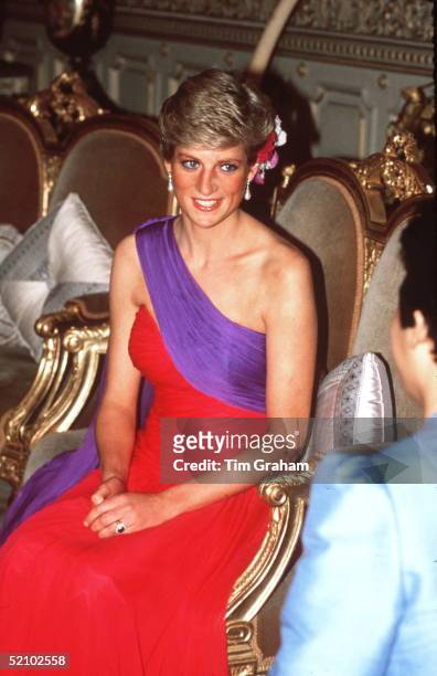 Princess Diana At A Dinner In Bangkok, Thailand In Febuary 1988 Wearing A Red And Purple Chiffon Evening Dress Designed By Fashion Designer Catherine...