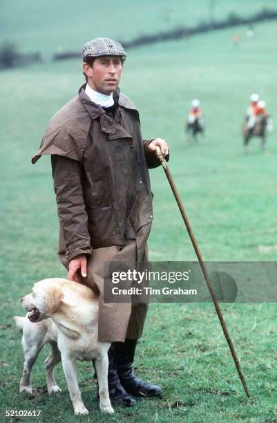 Prince Charles At The Fernie Hunt Cross Country Team Event Wearing Barbour Style/dryasabone Style Raincoat, Flat Cap And Walking Stick And With His...