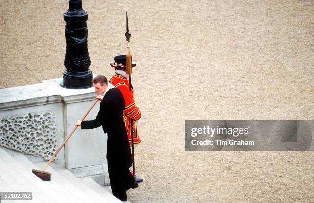 Member Of The Queen's Staff Sweeping The Steps Of Buckingham Palace Before A Garden Party.circa 1990s