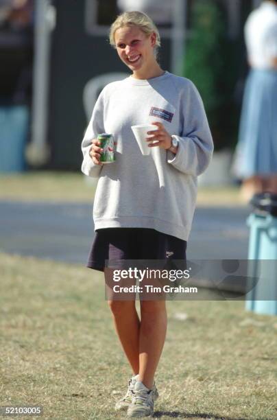 Zara Phillips Age 14 Smiling At The Gatcombe Park Horse Trials And Holding A Can Of 7up Lemonade In One Hand And A Cup In The Other. She Is Casually...
