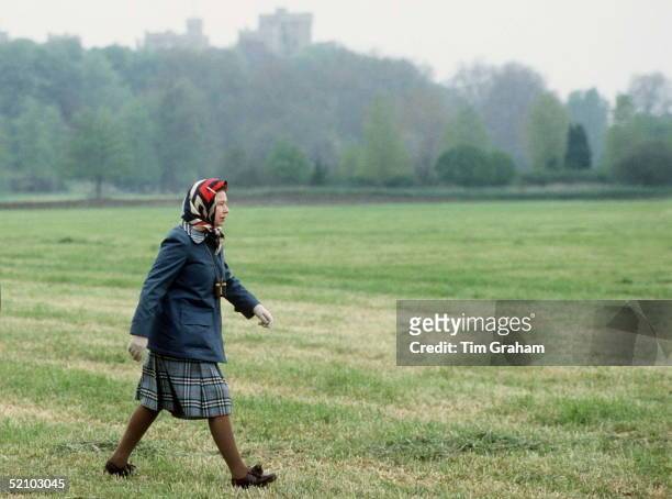 The Queen In Laced Up Brogue Shoes And Raincoat Walking In Windsor Great Park In The Grounds Of Windsor Castle