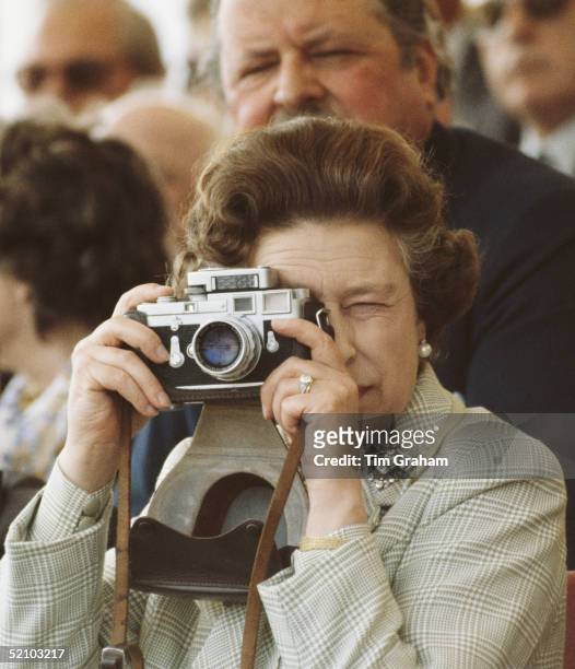 Queen Elizabeth II At The Windsor Horse Show, May 16, 1982. She Is Taking Pictures Of Her Husband With Her Leica M3 Camera, Wearing Her Engagement...
