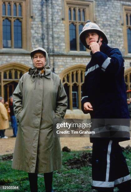 The Queen With Fireman Inspecting The Damage After The Fire At Windsor Castle.