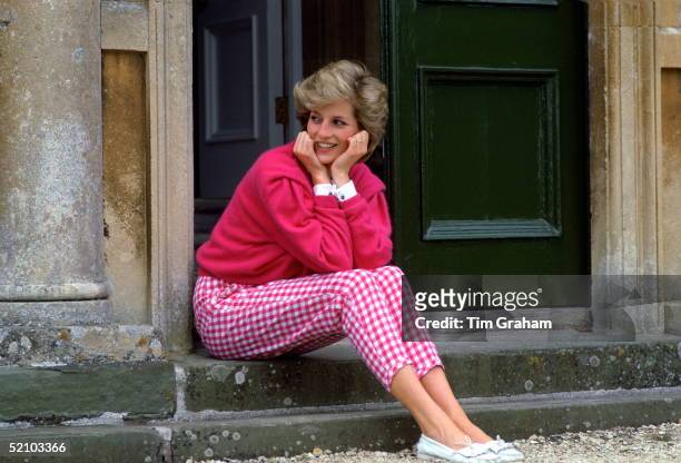Diana, Princess Of Wales, Sitting On The Steps Outside Her Country Home, Highgrove. The Princess Is Casually Dressed In Pink Gingham Trousers With A...