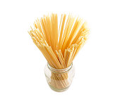 Two different uncooked long pasta in glass jar