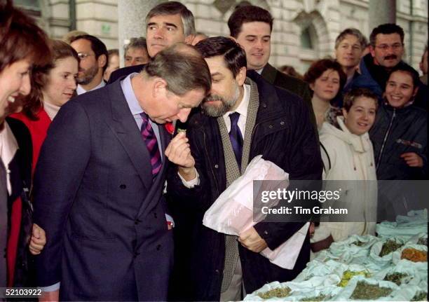 Prince Charles Visiting The Market In Ljubljana, Slovenia, Sniffing Herbs And Spices. His Bodyguard Colin Trimming Is Immediately Behind The Prince.