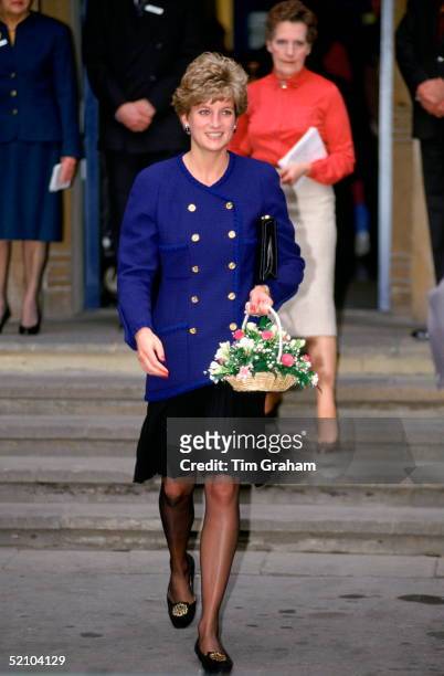 Diana, Princess Of Wales Carrying A Bouquet Of Flowers At Great Ormond Street Hospital For Children. Jacket Reported To Be By Fashion Designer Chanel.