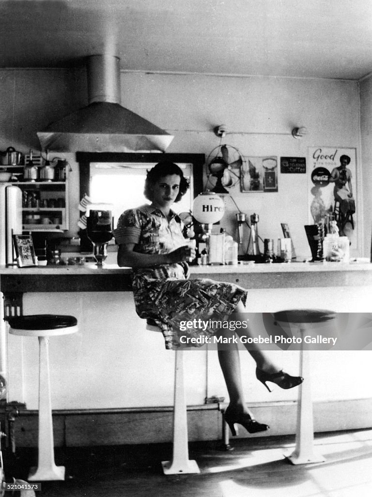 Woman Sitting At Lunch Counter