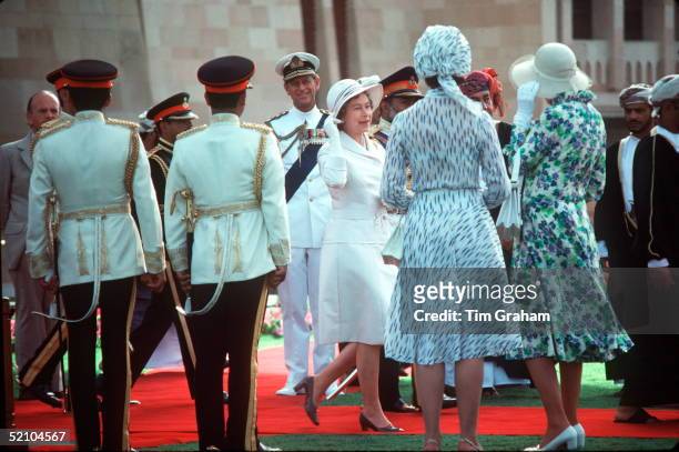 The Queen Arriving At Muscat Palace In Oman Chats With Her Ladies In Waiting About Her Hat Blowing Off
