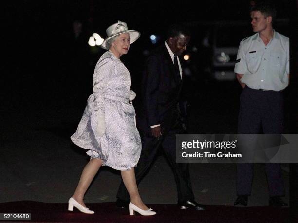 The Queen Arriving In Pretoria, South Africa To Be Greeted By Blustery Wind And A Thunder Storm.