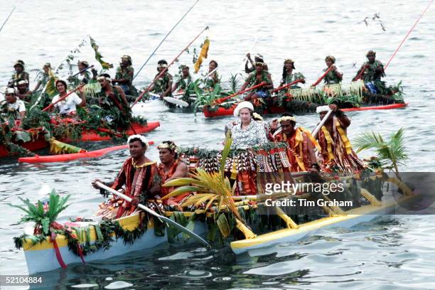 Queen Elizabeth Ll Being Rowed Ashore By Islanders From Tuvalu As She Sits In A Decorated Dug-out Canoe, Part Of Her Official Tour Of The South...