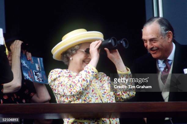 The Queen Using A Pair Of Binoculars To Watch The Racing During The Derby. With Her Is Racing Friend And Her Majesty's Representative At Ascot...