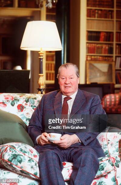 Diana's Father Earl Spencer At His Home Althorp House In Northhamptonshire. He Is Holding A Cup Of Tea In His Hand.