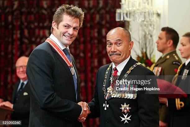 Former All Black captain Richie McCaw receives the insignia of a Member of the Order of New Zealand from Governor-General Sir Jerry Mateparae for...