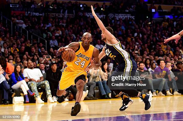 Kobe Bryant of the Los Angeles Lakers drives on Raul Neto of the Utah Jazz in the second half at Staples Center on April 13, 2016 in Los Angeles,...