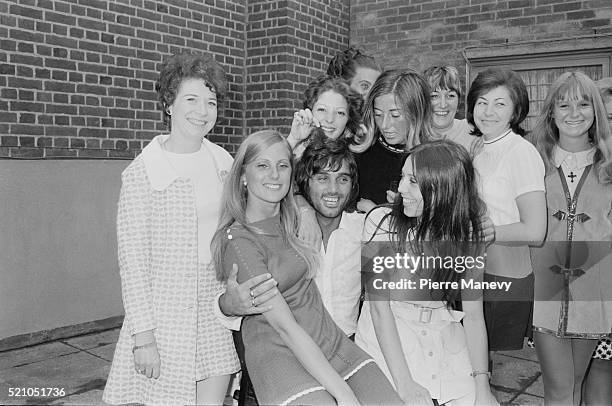 Northern Irish footballer George Best surrounded by young women, UK, 24th June 1970.
