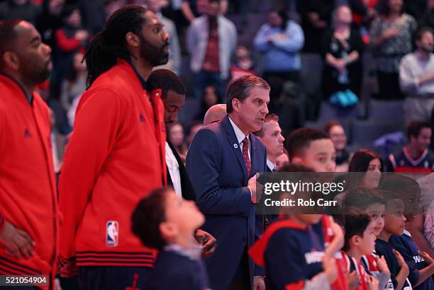 Head coach Randy Wittman of the Washington Wizards listens to the national anthem before the start of their game against the Atlanta Hawks at Verizon...