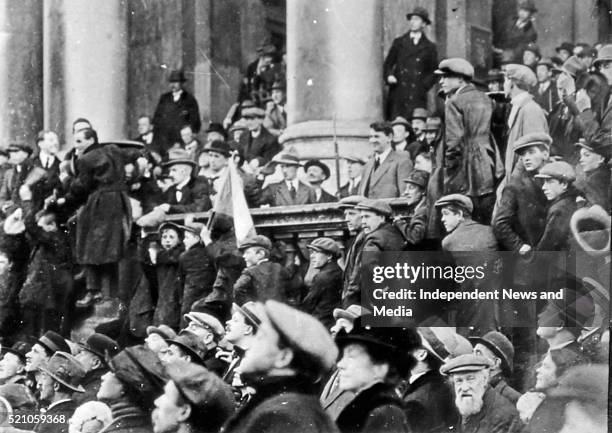 Michael Collins at City hall watching the national Army march past. Circa 1919. .