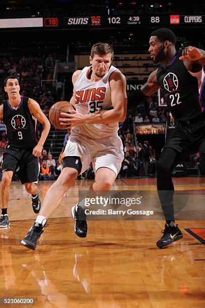 Mirza Teletovic of the Phoenix Suns drives against Branden Dawson of the Los Angeles Clippers on April 13 at Talking Stick Resort Arena in Phoenix,...