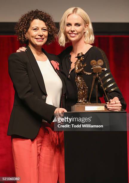 Universal Pictures Chairman Donna Langley and actress Charlize Theron speak onstage during the 2016 Will Rogers Pioneer of the Year Dinner Honoring...