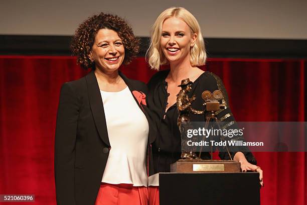 Universal Pictures Chairman Donna Langley and actress Charlize Theron speak onstage during the 2016 Will Rogers Pioneer of the Year Dinner Honoring...