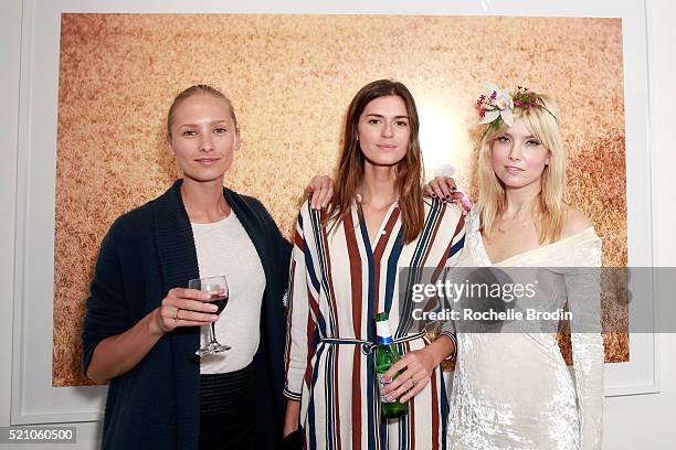 Models Nadya Panchenko and Beth Ostendorf, and actress Eugenia Kuzmina attend the Photo Femmes Exhibition Opening at De Re Gallery, featuring the...