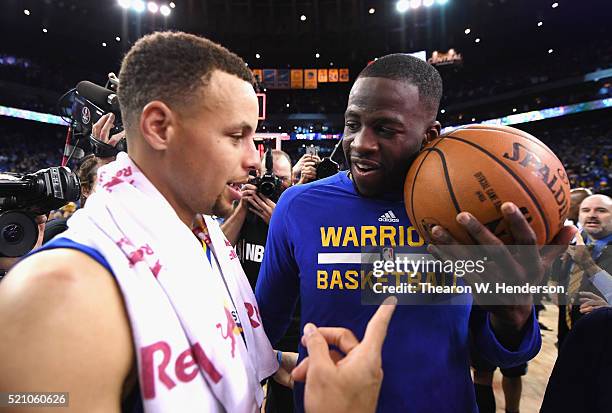 Stephen Curry of the Golden State Warriors and Draymond Green celebrate defeating the Memphis Grizzlies 125-104 at ORACLE Arena on April 13, 2016 in...