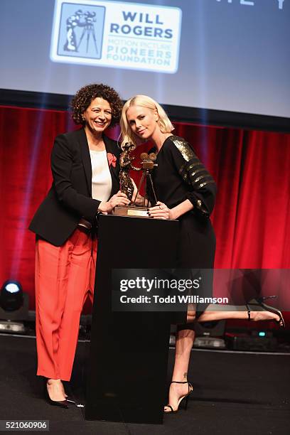 Universal Pictures Chairman Donna Langley and actress Charlize Theron speak onstage during the 2016 Will Rogers Pioneer of the Year Dinner Honoring...