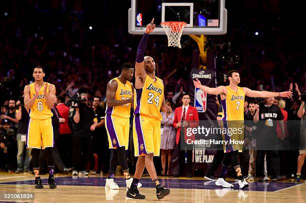 Kobe Bryant of the Los Angeles Lakers waves to the crowd as he is taken out of the game after scoring 60 points against the Utah Jazz at Staples...