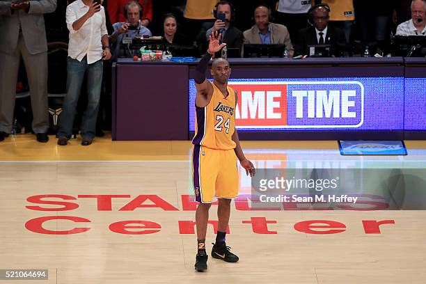 Kobe Bryant of the Los Angeles Lakers waves to the crowd as he is taken out of the game after scoring 60 points against the Utah Jazz at Staples...