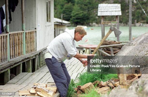 Prince William During His Raleigh International Expedition In Southern Chile, Chops Logs Outside The Team's Accommodation In The Village Of Tortel.
