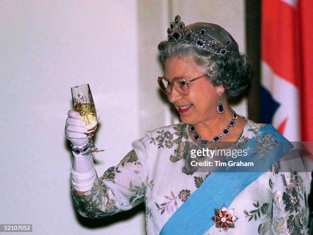 Queen At Banquet At Presidential Palace Toasting Her Host With A Glass Of Champagne In Warsaw During Her Visit To Poland.