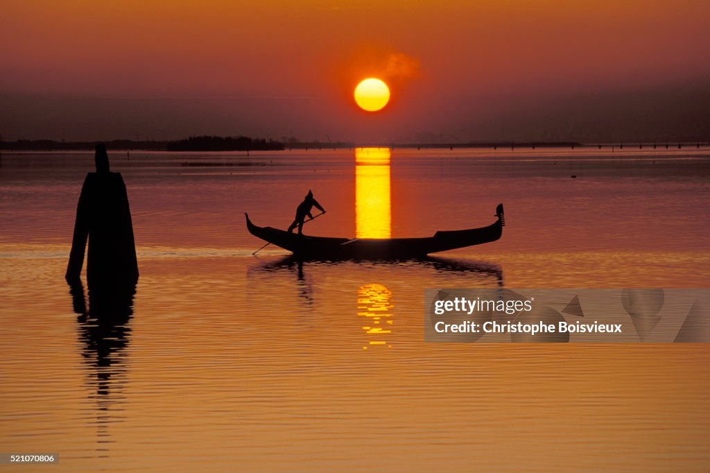 Gondolier at Sunset on Venice Lagoon